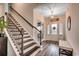 Bright foyer with hardwood floors, staircase, and stylish accents create a welcoming entry at 3091 Viceroy Loop, Little River, SC 29566