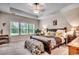 Serene primary bedroom with tray ceiling, large windows, and plush carpets at 3091 Viceroy Loop, Little River, SC 29566