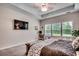 A spacious main bedroom featuring a tray ceiling, large windows, and a television on the wall at 3091 Viceroy Loop, Little River, SC 29566