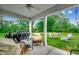 Relaxing outdoor patio area with seating, BBQ grill, and lush greenery for entertaining guests at 3091 Viceroy Loop, Little River, SC 29566
