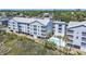 A high angle shot showcases condos, a pool, and surrounding lush greenery, enhancing the scenic appeal at 310 Marsh Pl. # 108, Murrells Inlet, SC 29576
