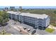 Aerial view of condo building with parking and glimpses of the beautiful beach nearby at 310 Marsh Pl. # 108, Murrells Inlet, SC 29576