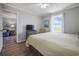 Comfortable bedroom with wood floors, a ceiling fan and relaxing view out the window at 310 Marsh Pl. # 108, Murrells Inlet, SC 29576