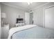 View of cozy bedroom features wood floors, large bed, ceiling fan, and closet at 310 Marsh Pl. # 108, Murrells Inlet, SC 29576