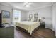 Cozy bedroom featuring a large bed, ceiling fan, dresser, and a view to the outside at 310 Marsh Pl. # 108, Murrells Inlet, SC 29576