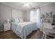 This bedroom features attractive wood floors, a large bed, and a sunny window at 310 Marsh Pl. # 108, Murrells Inlet, SC 29576