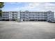 Condominium building exterior featuring a raised structure, parking, and stairwells to access units at 310 Marsh Pl. # 108, Murrells Inlet, SC 29576
