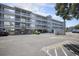 View of condo building exterior with elevated structure above parking, multiple balconies and exterior access stairwells at 310 Marsh Pl. # 108, Murrells Inlet, SC 29576