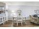 Dining area with a white table and chairs set, complemented by modern flooring and decor at 310 Marsh Pl. # 108, Murrells Inlet, SC 29576
