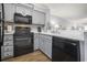 Updated kitchen featuring modern gray cabinets and sleek black appliances, bright and clean at 310 Marsh Pl. # 108, Murrells Inlet, SC 29576