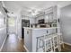 Bright kitchen with grey cabinets, black appliances and bar stool seating at the breakfast bar at 310 Marsh Pl. # 108, Murrells Inlet, SC 29576
