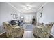 Comfortable living room with neutral walls, a sliding door to a screen porch, and wood flooring at 310 Marsh Pl. # 108, Murrells Inlet, SC 29576