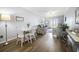 Inviting living room with a dining area, balcony, comfortable seating, and beautiful wood flooring at 310 Marsh Pl. # 108, Murrells Inlet, SC 29576