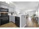 Bright living space featuring a kitchen with gray cabinets and views to the living area at 310 Marsh Pl. # 108, Murrells Inlet, SC 29576