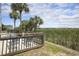 Outdoor patio with palm trees overlooking a scenic marsh view, perfect for relaxation at 310 Marsh Pl. # 108, Murrells Inlet, SC 29576