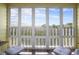 Exterior view from the screened-in porch overlooking the landscape and nearby homes at 310 Marsh Pl. # 108, Murrells Inlet, SC 29576