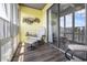 Cozy screened-in porch offering a relaxing seating area with natural light and sliding door access at 310 Marsh Pl. # 108, Murrells Inlet, SC 29576