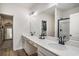 Bright bathroom with double vanities, a walk-in closet, and a modern walk-in shower at 3129 Palma Way, Myrtle Beach, SC 29579