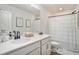 Modern bathroom featuring a white vanity, decorative mirror, and shower with patterned curtain at 3129 Palma Way, Myrtle Beach, SC 29579