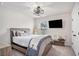 Cozy bedroom with rustic wood bed frame, ceiling fan, and a mounted television at 3129 Palma Way, Myrtle Beach, SC 29579