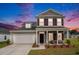 Charming two-story home with gray siding, shutters, a well-manicured lawn, and a welcoming front porch at 3129 Palma Way, Myrtle Beach, SC 29579