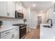Modern kitchen with white cabinets, quartz countertops, and stainless steel appliances at 3129 Palma Way, Myrtle Beach, SC 29579