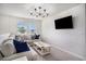 Comfortable living room featuring a large sectional sofa, stylish chandelier, and mounted television at 3129 Palma Way, Myrtle Beach, SC 29579