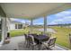 Relaxing screened porch with outdoor dining set and scenic backyard pond view at 3129 Palma Way, Myrtle Beach, SC 29579