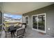 Covered porch with dining set, offering views of the backyard and neighboring houses at 3129 Palma Way, Myrtle Beach, SC 29579