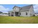 A charming gray home featuring a spacious screened in porch, perfect for enjoying the outdoors at 3129 Palma Way, Myrtle Beach, SC 29579