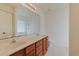 Bathroom featuring double sinks, tile floors, and shower with a glass block window at 316 Watercress Dr., Longs, SC 29568