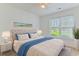 Well-furnished bedroom with a large window, stylish bed, and tasteful decor at 316 Watercress Dr., Longs, SC 29568
