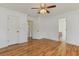 Spacious bedroom with hardwood floors and open doorway to the bathroom at 316 Watercress Dr., Longs, SC 29568