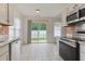 Bright kitchen with stainless steel appliances and a sliding glass door to the yard at 316 Watercress Dr., Longs, SC 29568