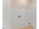 This laundry room has a tile floor, a wire shelf for storage and all the necessary hookups at 316 Watercress Dr., Longs, SC 29568