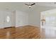 Open-concept living space with hardwood floors leading to the front door and kitchen at 316 Watercress Dr., Longs, SC 29568