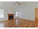 Living room with a vaulted ceiling, wood floors, fireplace, and natural lighting at 316 Watercress Dr., Longs, SC 29568