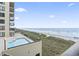 Aerial view from a balcony showing the beach, ocean, pool and condominium complex at 4000 N Ocean Blvd. # 506, North Myrtle Beach, SC 29582
