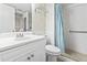 Bright bathroom featuring a pristine white vanity, fixtures and a shower with accessibility features at 4000 N Ocean Blvd. # 506, North Myrtle Beach, SC 29582