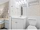 Sparkling bathroom with a modern vanity and mirror, complemented by coastal-themed wallpaper at 4000 N Ocean Blvd. # 506, North Myrtle Beach, SC 29582