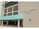 A well-maintained entrance to Buena Vista Plaza 4000, featuring a covered parking area and accessible access at 4000 N Ocean Blvd. # 506, North Myrtle Beach, SC 29582