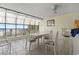 Bright sunroom dining area with tile floors, ceiling fan, and ocean views at 4000 N Ocean Blvd. # 506, North Myrtle Beach, SC 29582