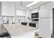 Well-equipped kitchen area with breakfast bar and white appliances at 4000 N Ocean Blvd. # 506, North Myrtle Beach, SC 29582