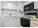 A close up of kitchen appliances, featuring white cabinetry and subway tile backsplash at 4000 N Ocean Blvd. # 506, North Myrtle Beach, SC 29582