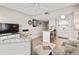 Comfortable living room features a counter with bar stools and a kitchen with modern appliances and tile flooring at 4000 N Ocean Blvd. # 506, North Myrtle Beach, SC 29582