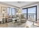 Cozy living room with a view, featuring a floral sofa, recliner, and balcony overlooking the ocean at 4000 N Ocean Blvd. # 506, North Myrtle Beach, SC 29582