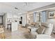 Bright condo living space with a ceiling fan, view of ocean and a full kitchen featuring tile floors and white cabinets at 4000 N Ocean Blvd. # 506, North Myrtle Beach, SC 29582