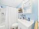 A bright bathroom features a vanity, toilet, and shower/tub with blue walls at 401 17Th Ave. S, North Myrtle Beach, SC 29582