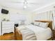 Bright bedroom featuring a wooden-framed bed, ceiling fan, hardwood floors and natural light at 401 17Th Ave. S, North Myrtle Beach, SC 29582