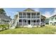 Charming home with a spacious, covered porch, featuring a two-story floor plan and manicured lawn at 401 17Th Ave. S, North Myrtle Beach, SC 29582